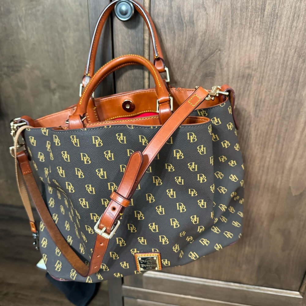 Dooney & Burke purse— numerous compartments with shoulder strap.